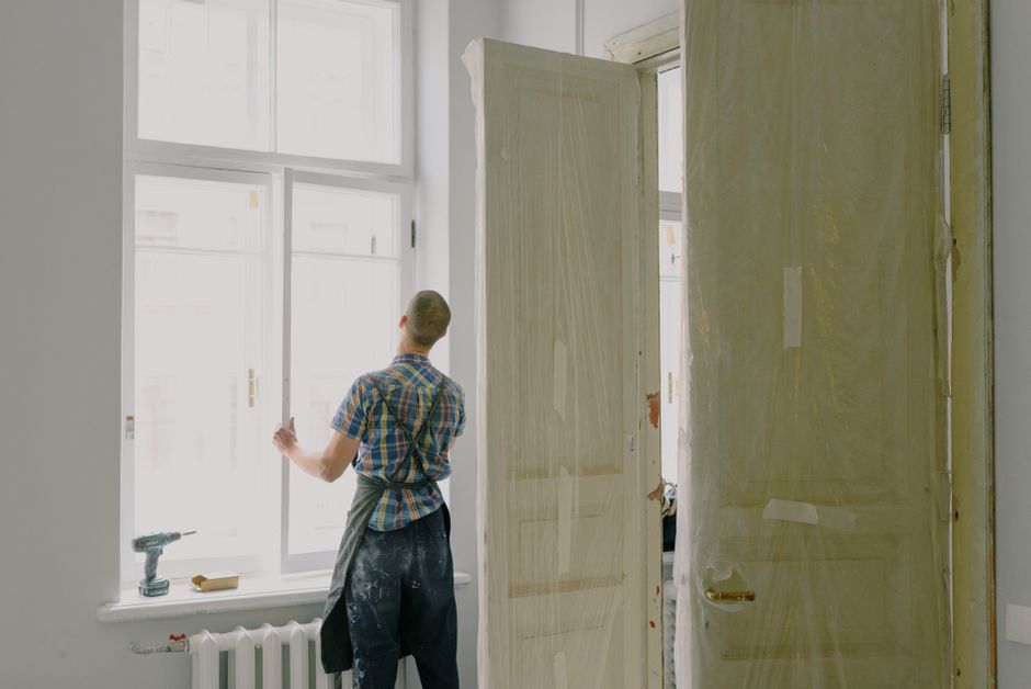 Workers fitting a window into a wall opening